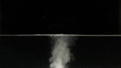 Pill dissolving in a water tank in slow motion Stock Footage 88801419