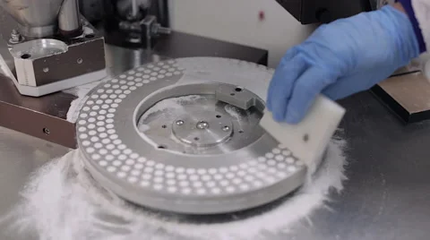 Pill Encapsulation Machine - Scraping Off Excess Powder Stock Footage 67888431