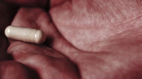 Pill falling in an open palm. Stock Footage 82877951
