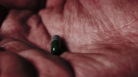 Pill falling in an open palm. Stock Footage 82877991