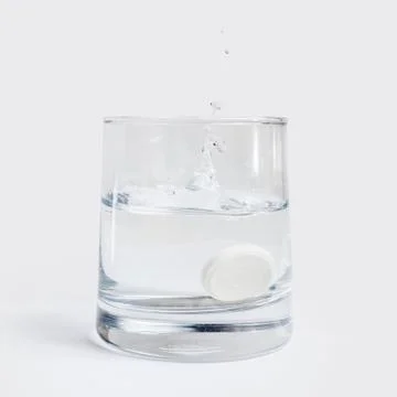 Pill in a glass Stock Photos