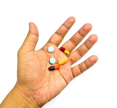 Pill in a hand isolated on white background Foto stock