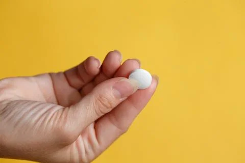 Pill in hand Stock Photos