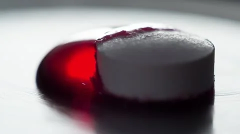 Pill morphs with red dye Stock Footage 21761159