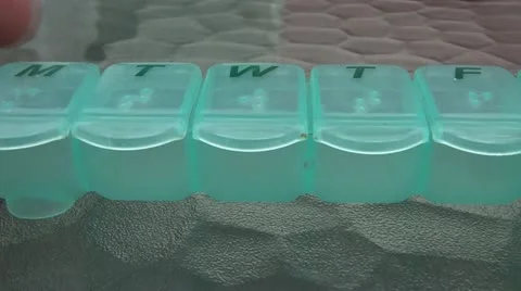 Pill Organizer Calculating Video stock 12610215
