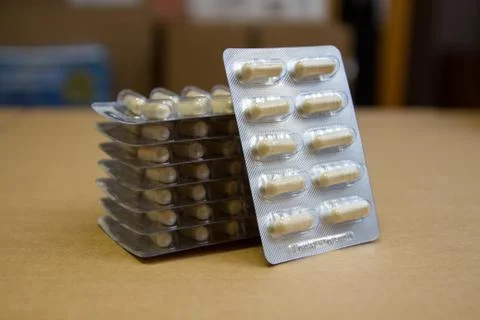 Pill packaging on a cardboard background. Stock Photos