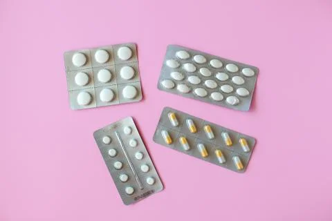 Pill packaging on pink background. Stock Photos