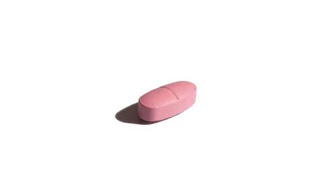 Pill of pink color on a white background. Isolated. Hard shadows Stock Photos