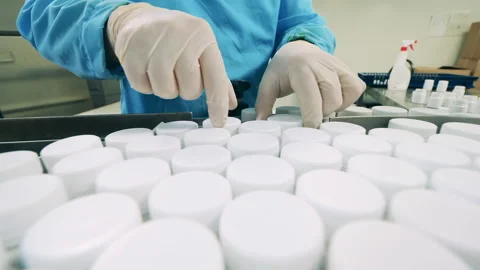 Pill tubs are getting relocated onto the conveyor Stock-Footage 160416797
