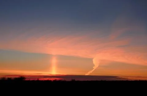 Pillar of sunlight in the sky after sunset Stock Photos