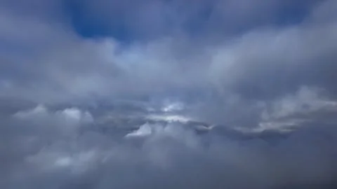 Pillot POV Flying Between Layers of Darkening Clouds Breaking Into Clear Sky Stock Footage 346750941