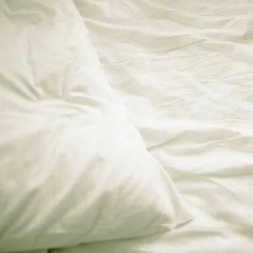 A pillow on a bed Stock Photos