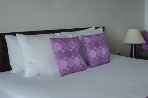 Pillow on bed Stock Photos