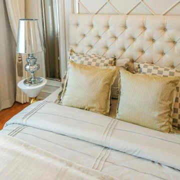 Pillows on bed and lamp Foto stock