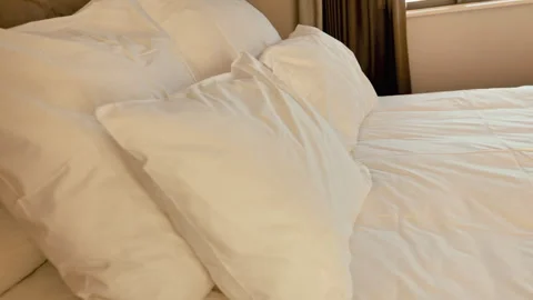 Pillows on bed in hotel room Stock Footage 314082811