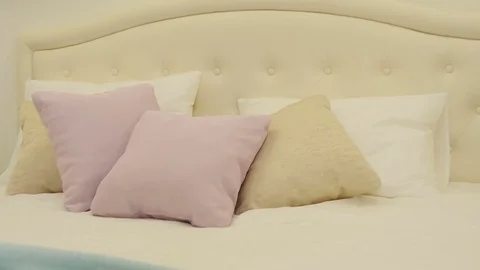 Pillows on the bright bed Stock Footage 75937845