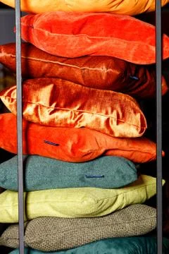 Pillows from different textile fabrics are stacked on top of each other. Foto stock