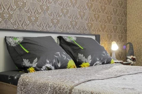Pillows on the double bed in the bedroom Stock Photos