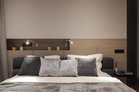 Pillows on the double bed in the bedroom Stock Photos