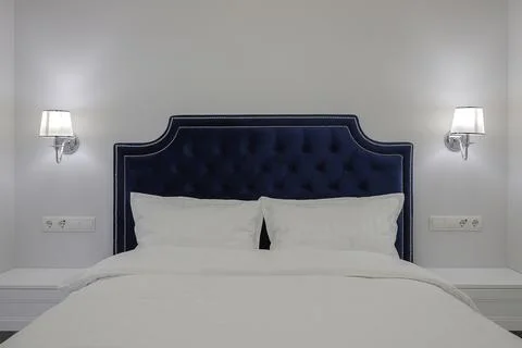Pillows on the double bed in the bedroom Stock Photos