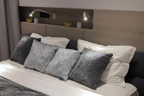 Pillows on the double bed in the bedroom Stock Photos