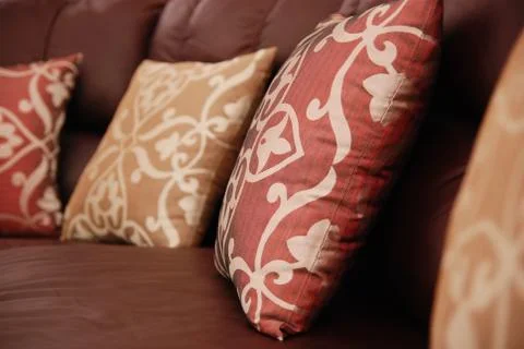 Pillows on a leather sofa Stock Photos