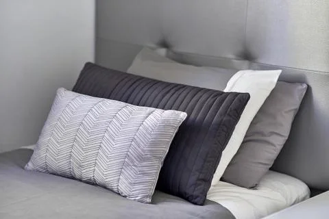 Pillows in a row on the bed in the bedroom Stock Photos