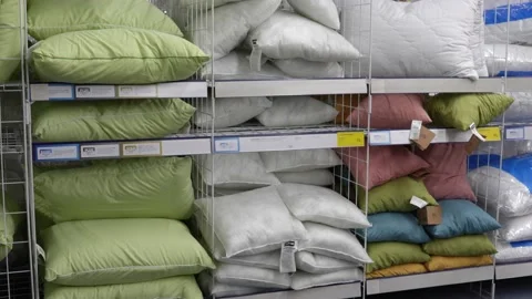 Pillows for sleeping in different sizes on the shelves in the store. Stock-Footage 232984125