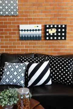 Pillows on a sofa with brick wall in background 스톡 사진