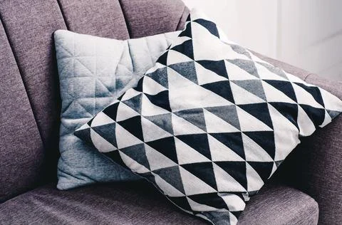 Pillows on sofa in room Stock Photos