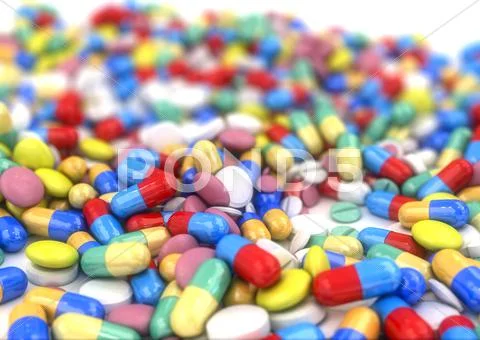 Pills and capsules placed on a table Stock Photos