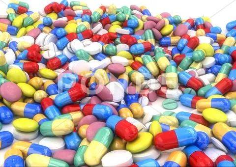 Pills and capsules placed on a table Stock Photos