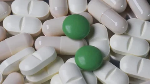 Pills and Capsules Rotating Clockwise Close Up in Macro Shot Stock Footage 303512326