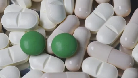 Pills and Capsules Rotating Counterclockwise Close Up in Macro Shot Stock Footage 303512333