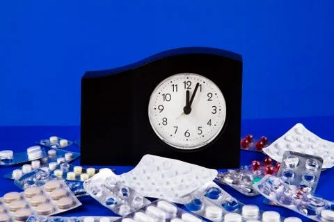Pills and a Clock Stock Photos