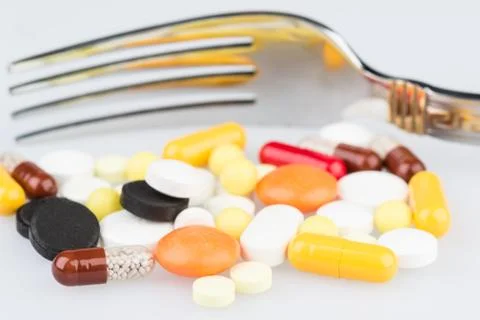 Pills and dining fork Foto stock