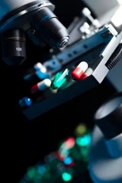 Pills and microscope Stock Photos