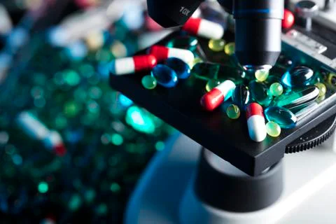 Pills and microscope Stock Photos