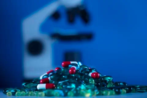 Pills and microscope Stock Photos