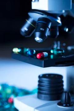 Pills and microscope Stock Photos