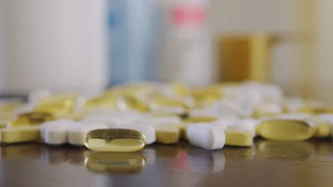 Pills and vitamins close up on the table dolly shot using shallow depth of field Stock-Footage 125636893