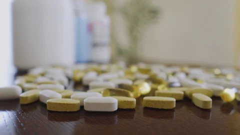 Pills and vitamins close up on the table dolly shot using shallow depth of field Stock Footage 126570210