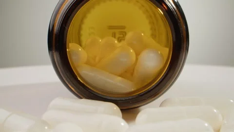 Pills and vitamins macro, Close up view of womans hands holding plenty of Stock Footage 309639440