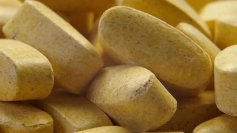 Pills with biologically active additives rotation macro shot Stockbeeldmateriaal 155139567