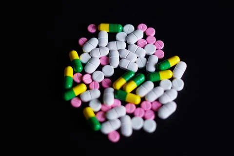 Pills on black background Photos