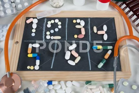 Pills In Blackboard On White Background