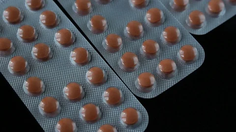 Pills in blister moving on black background. newest medical discoveries. Stock Footage 126696495