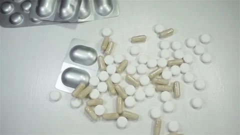 Pills in blisters falling in slow motion Stock Footage 152964504