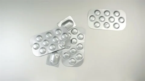 Pills in blisters falling in slow motion Stock Footage 153072402