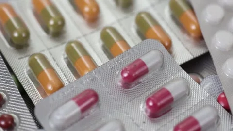 Pills in blisters rotating through shot in a seamless loop Stock Footage 280677725